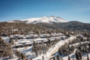 The resort buildings in the snow, seen from above, with the Tenmile Range behind
