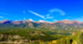The Tenmile Range in summer, green forest below the bare ridges